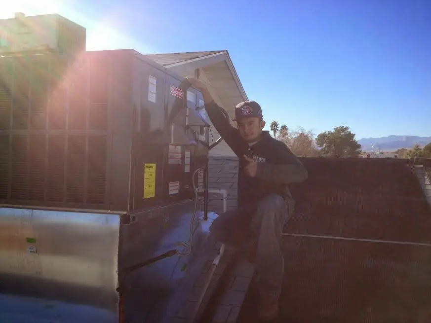 HVAC technician performing Boiler Repair on a rooftop unit in Eden